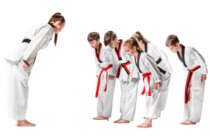 Kids bowing to taekwondo master